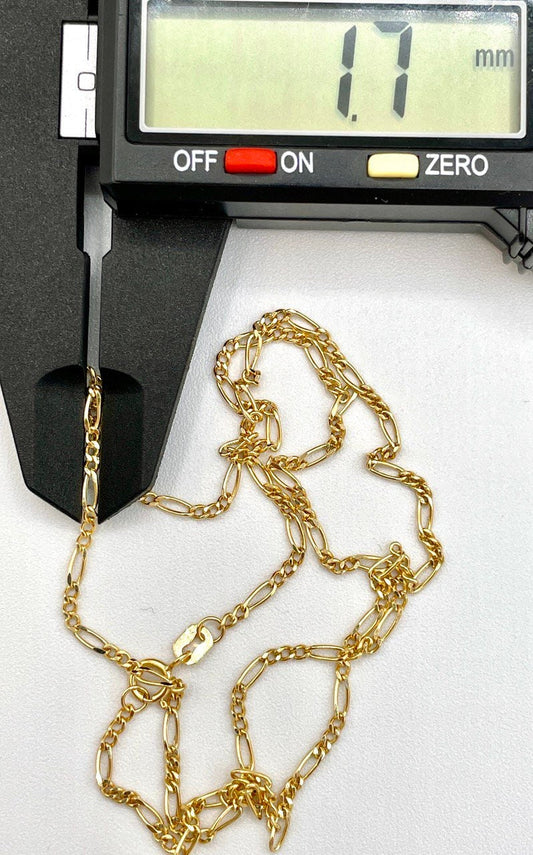 Gold chain being measured with a digital caliper on a white background