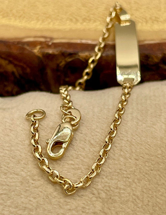Gold chain bracelet on a textured surface