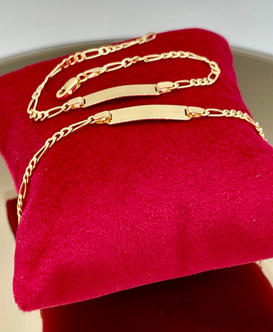Gold necklaces on a red cushion