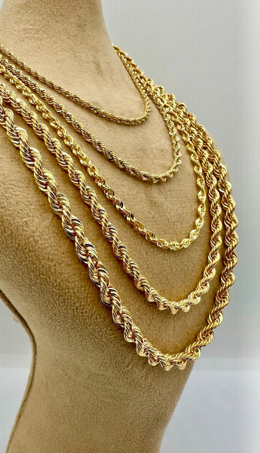 Gold rope chains displayed on a mannequin bust against a white background