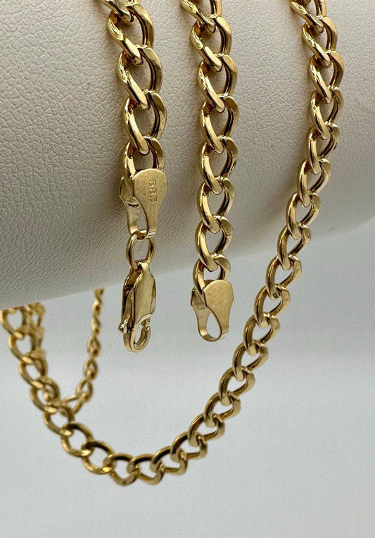 Gold chain necklace on a white background