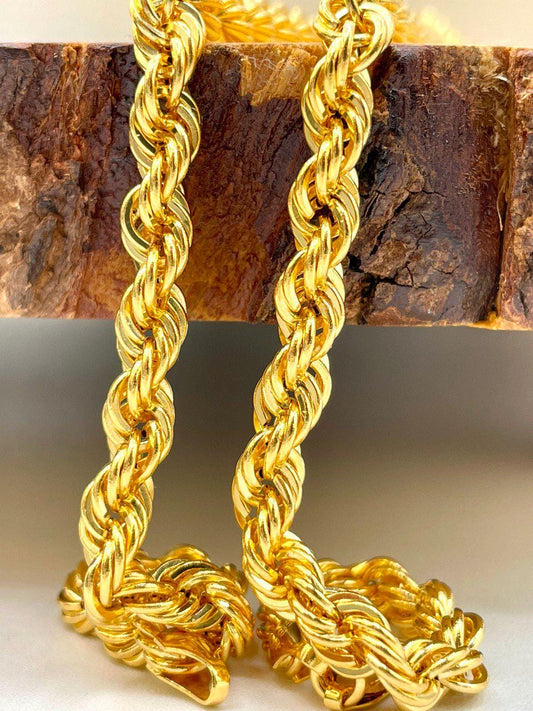 Gold rope chain necklace on a wooden block
