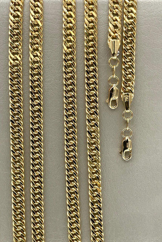 Gold chain necklaces of different lengths on a gray background