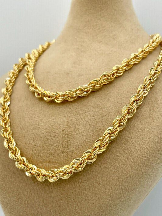 Two gold rope chains on a mannequin neck.