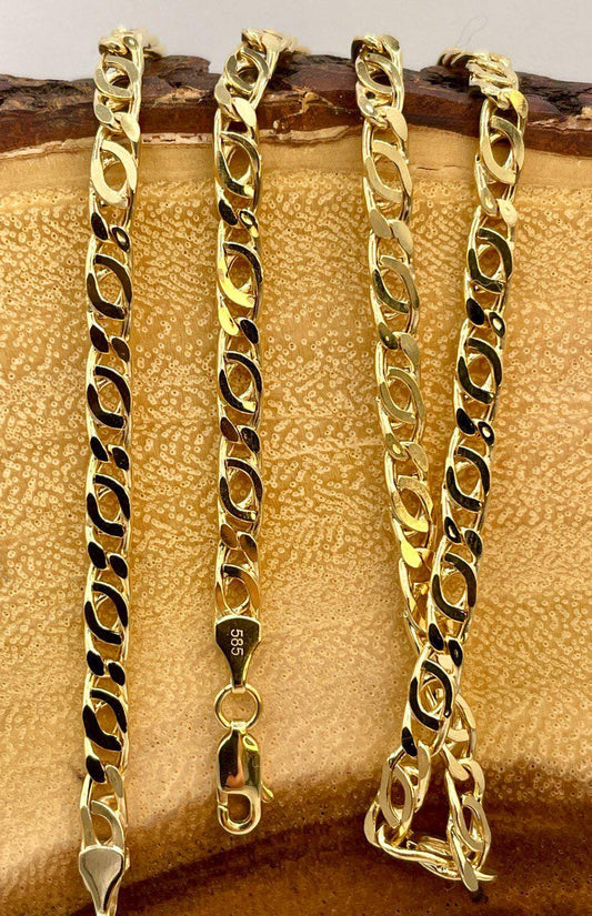 Two gold chains on a textured surface