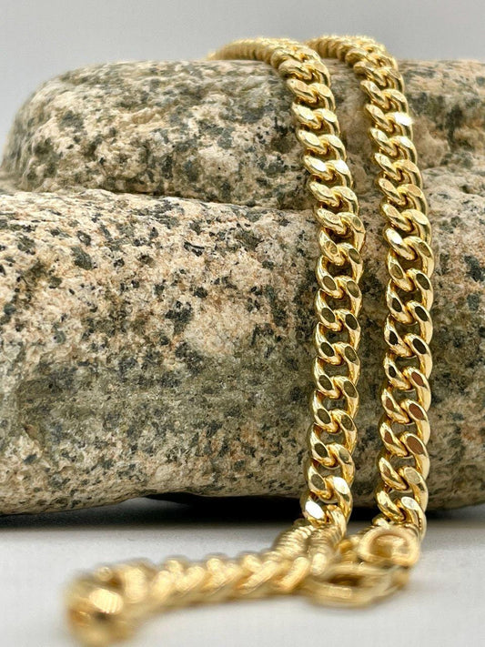 Gold chain on a stone surface