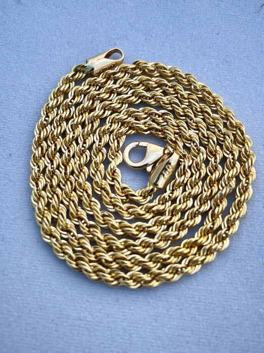 Gold chain necklace on a blue background