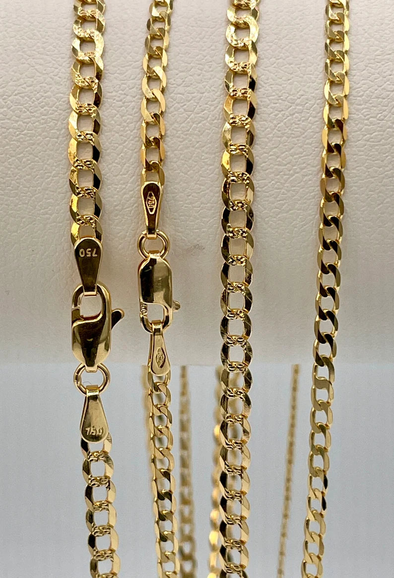 Gold chain necklace on a light gray background