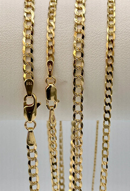 Gold chain necklace on a light gray background