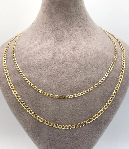 Gold chain necklace on a mannequin bust against a white background