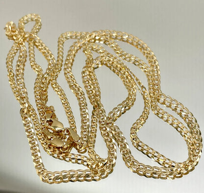 Gold chain necklace on a light gray background