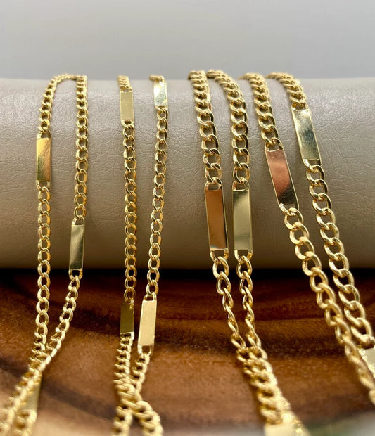 Gold chains of various designs on a textured surface