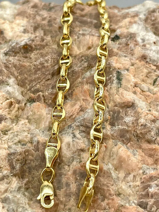 Gold chain on a textured stone surface