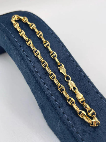 Gold chain on a blue textured surface