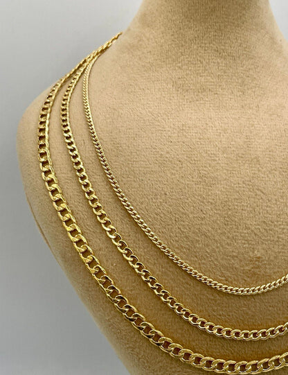 Gold chain necklace displayed on a mannequin bust against a neutral background