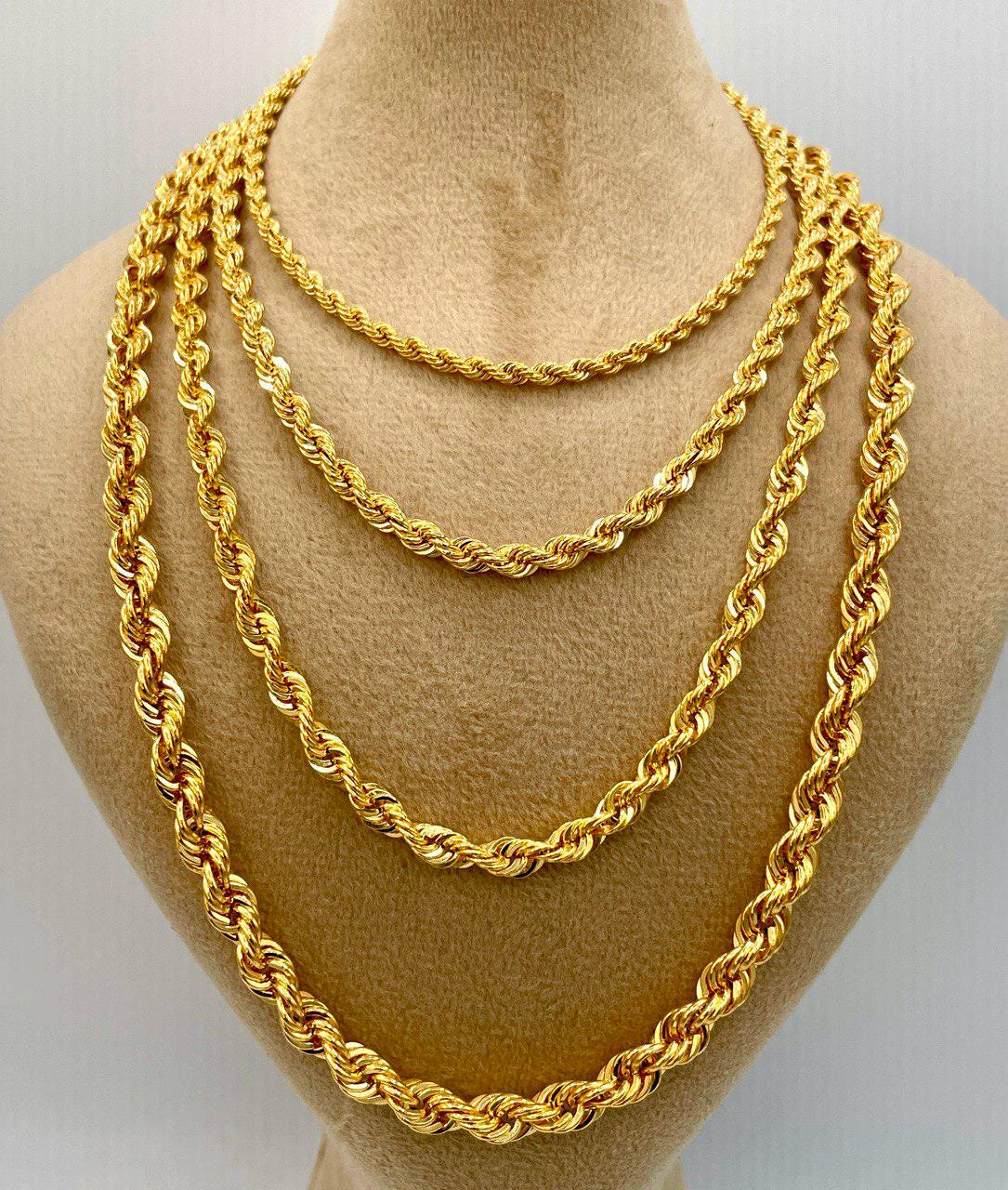 Three gold rope chains displayed on a mannequin bust.