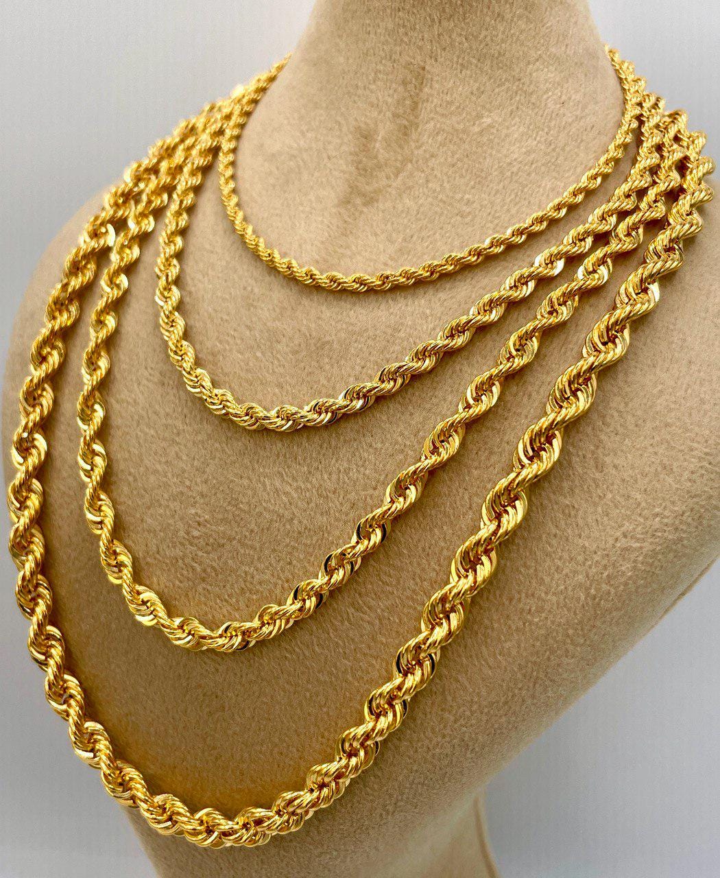 Three gold rope chains displayed on a mannequin neck.