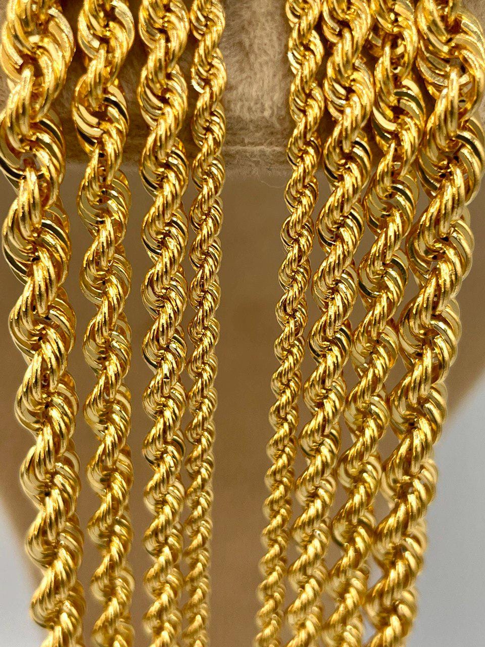 Close-up of gold rope chains on a gradient background