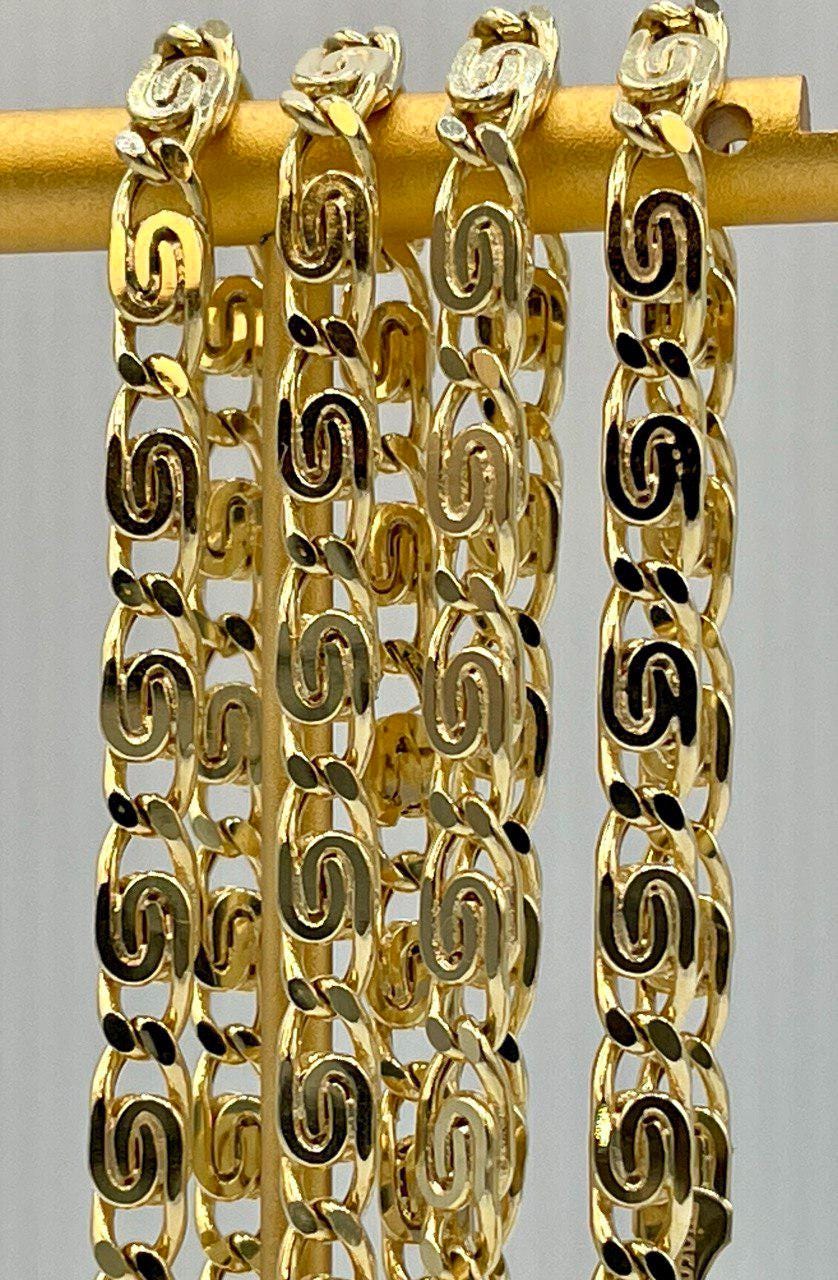 Gold chain bracelet on a gray background