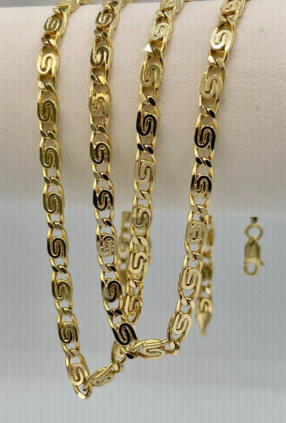 Gold chain necklace on a white surface