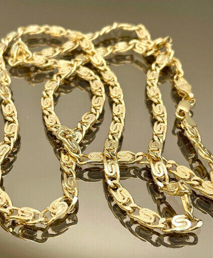 Gold chain on a reflective surface